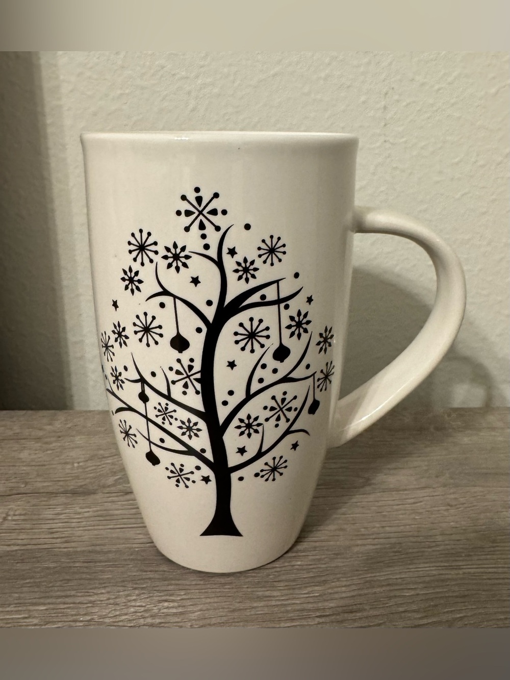Sweet Expressions. A tall white ceramic mug featuring a black winter tree design